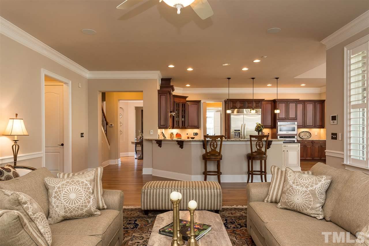 3929 Colinwood Lane Raleigh, NC 27606 - Photo 7 of 24 a living room with lots of furniture and a view of kitchen