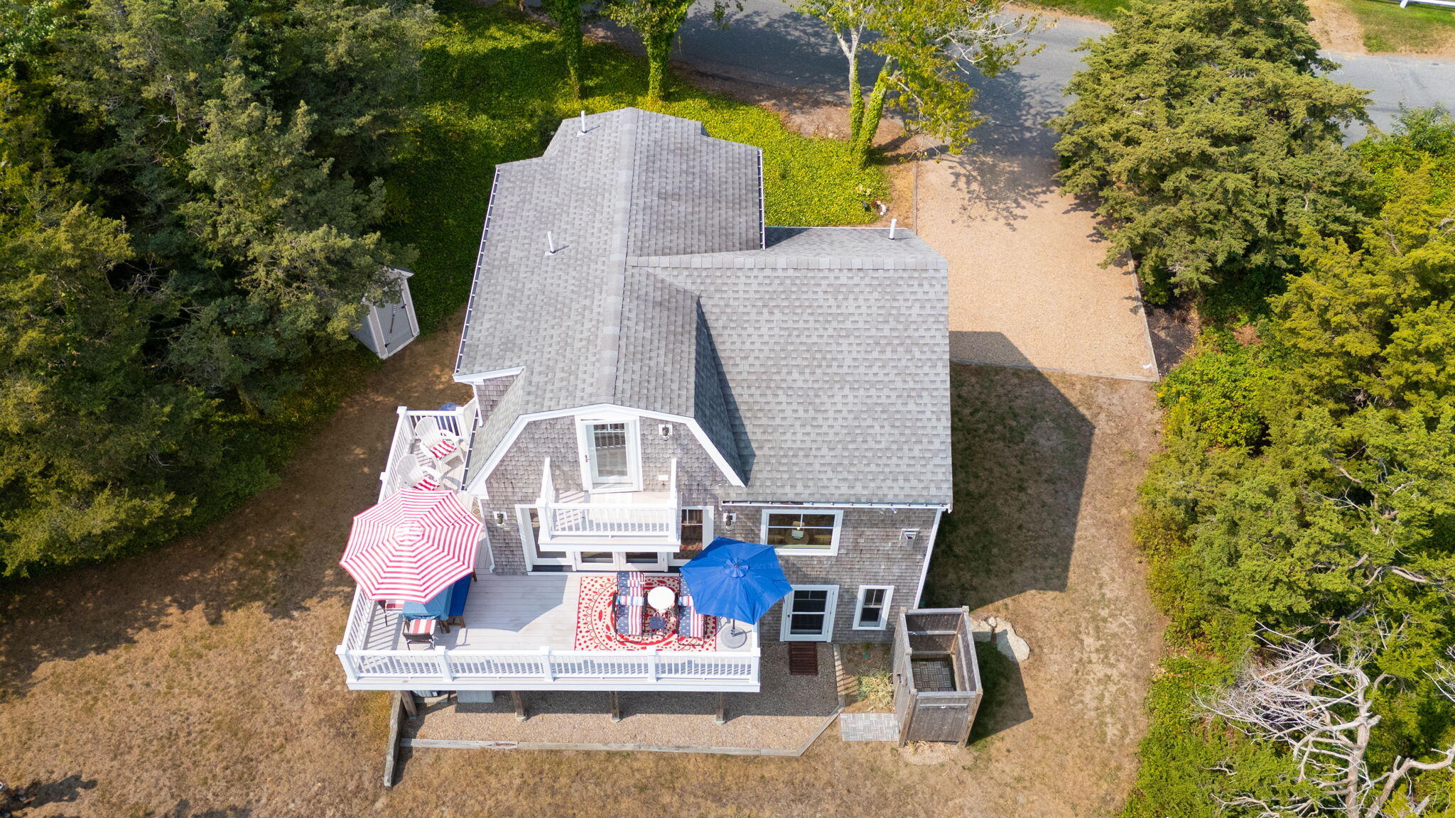 63 Briar Spring Road Orleans, MA 02653 - Photo 23 of 37 an aerial view of a house with outdoor space and trees all around