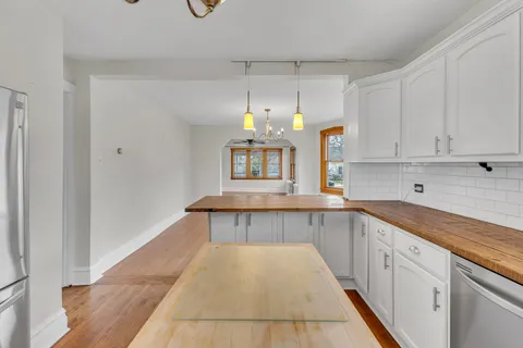 a view of a living room and chandelier
