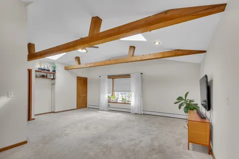 a view of a kitchen with kitchen island a sink appliances and a counter top space