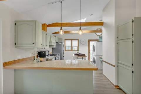 a view of a chairs and table on the wooden floor