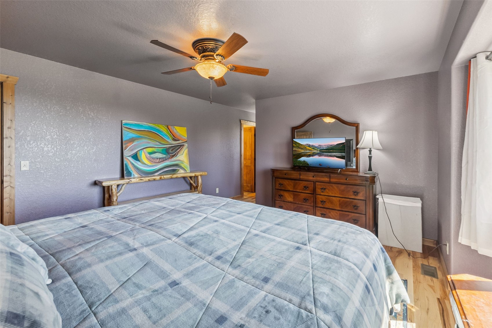 889 Venture Road Fairplay, CO 80440 - Photo 14 of 38 a bedroom with a bed and a chandelier