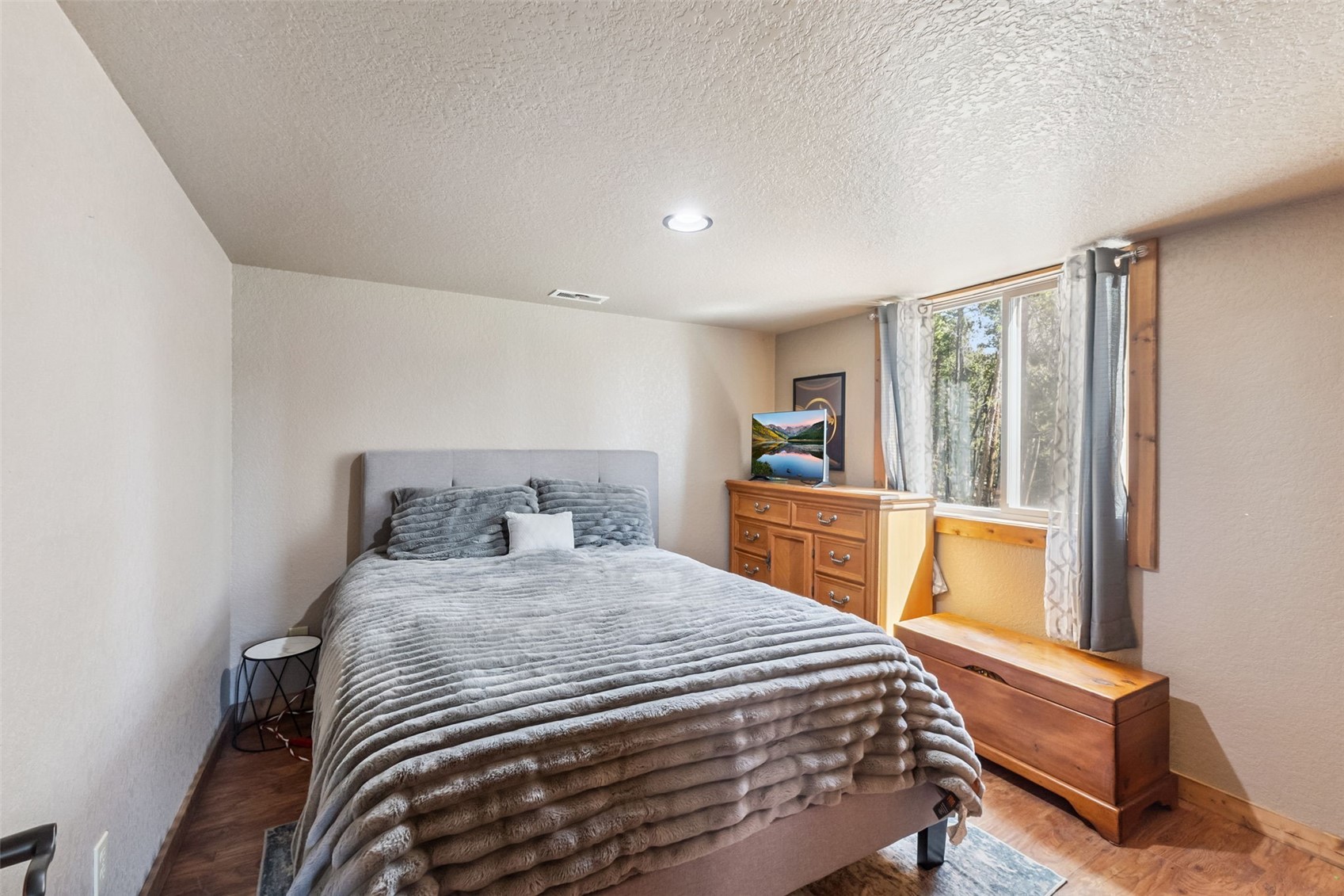 889 Venture Road Fairplay, CO 80440 - Photo 19 of 38 a bedroom with a bed and wooden floor