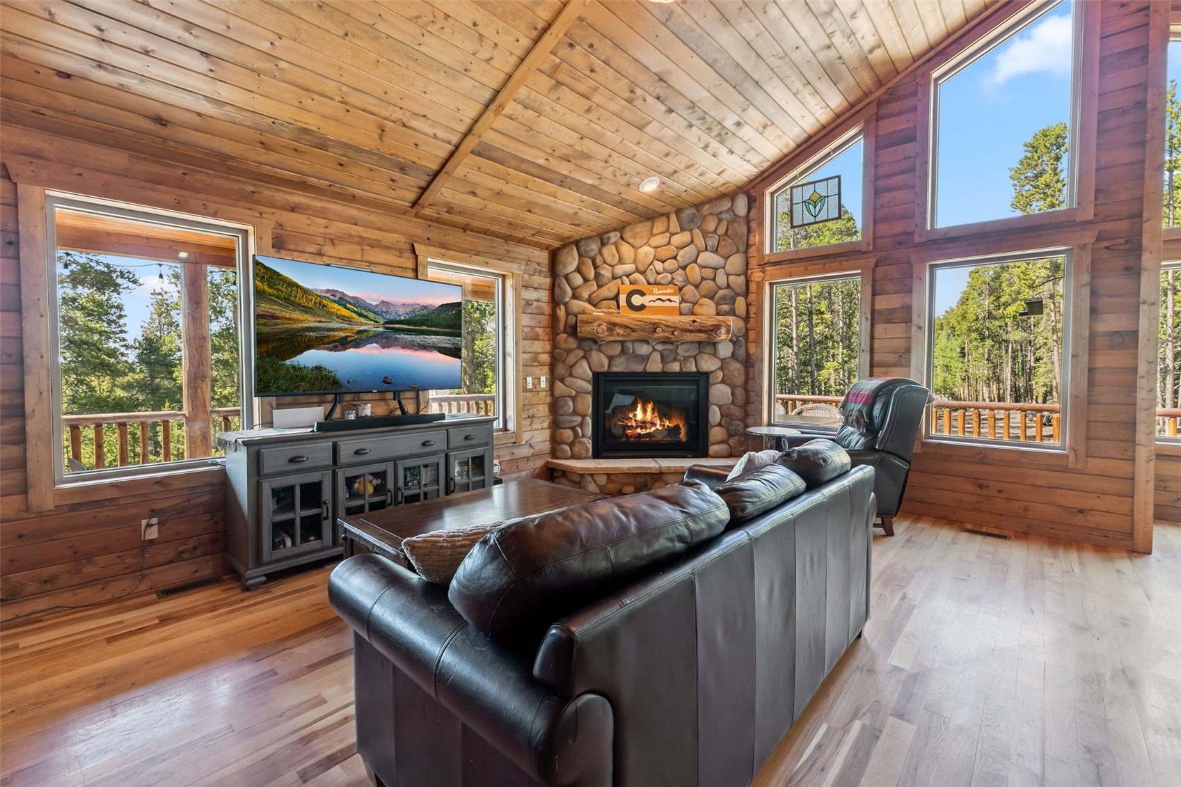 889 Venture Road Fairplay, CO 80440 - Photo 7 of 38 a living room with furniture a flat screen tv and a fireplace