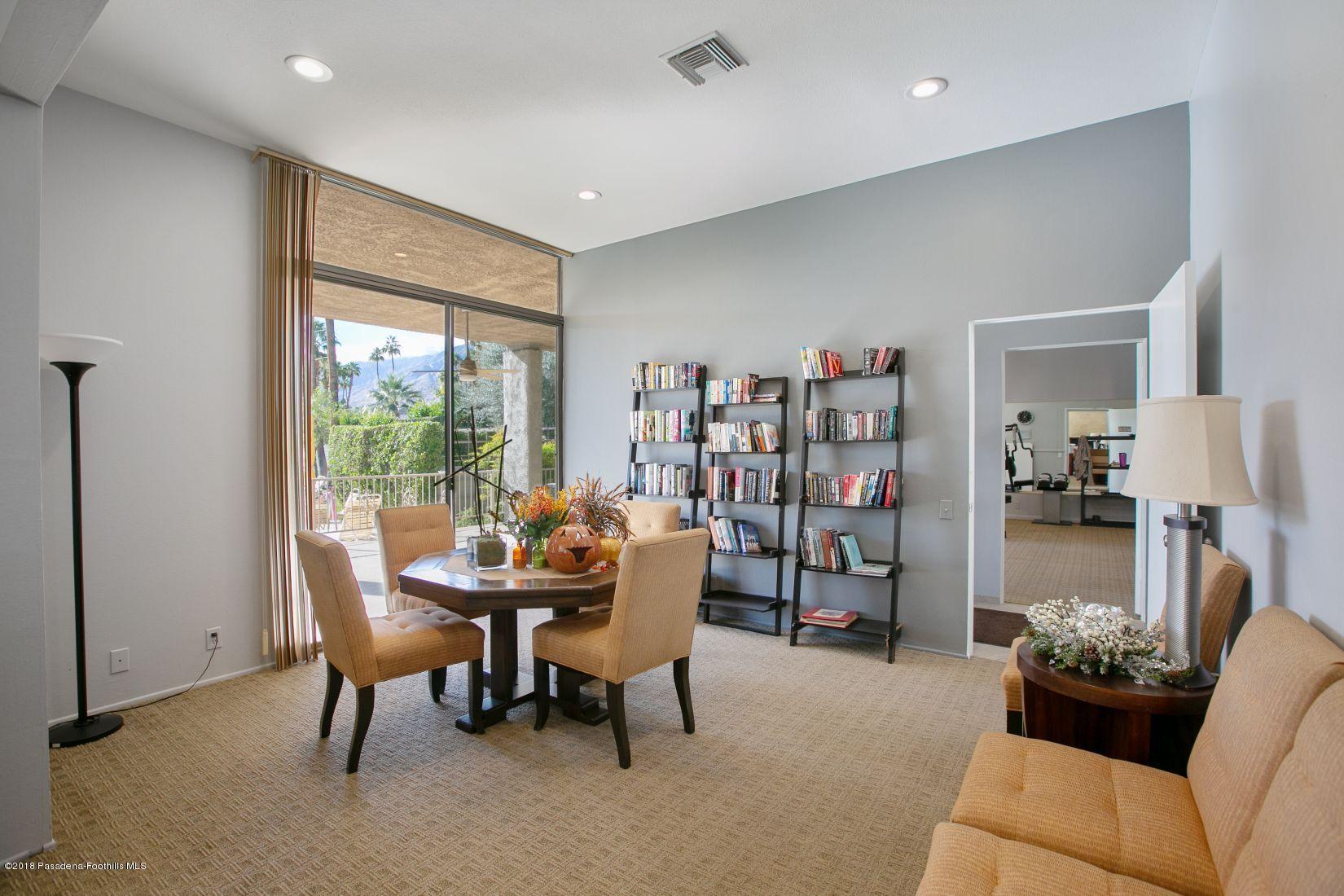 1111 East Ramon Road, Unit 85 Palm Springs, CA 92264 - Photo 24 of 29 a living room with furniture and a bookshelf