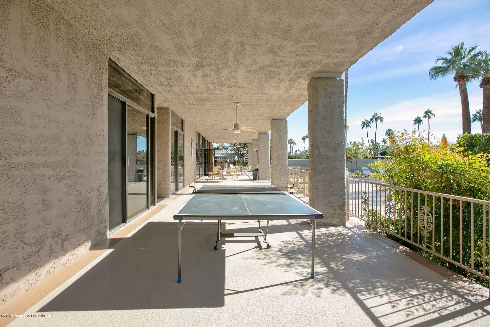 1111 East Ramon Road, Unit 85 Palm Springs, CA 92264 - Photo 26 of 29 a living room with a couch and potted plants