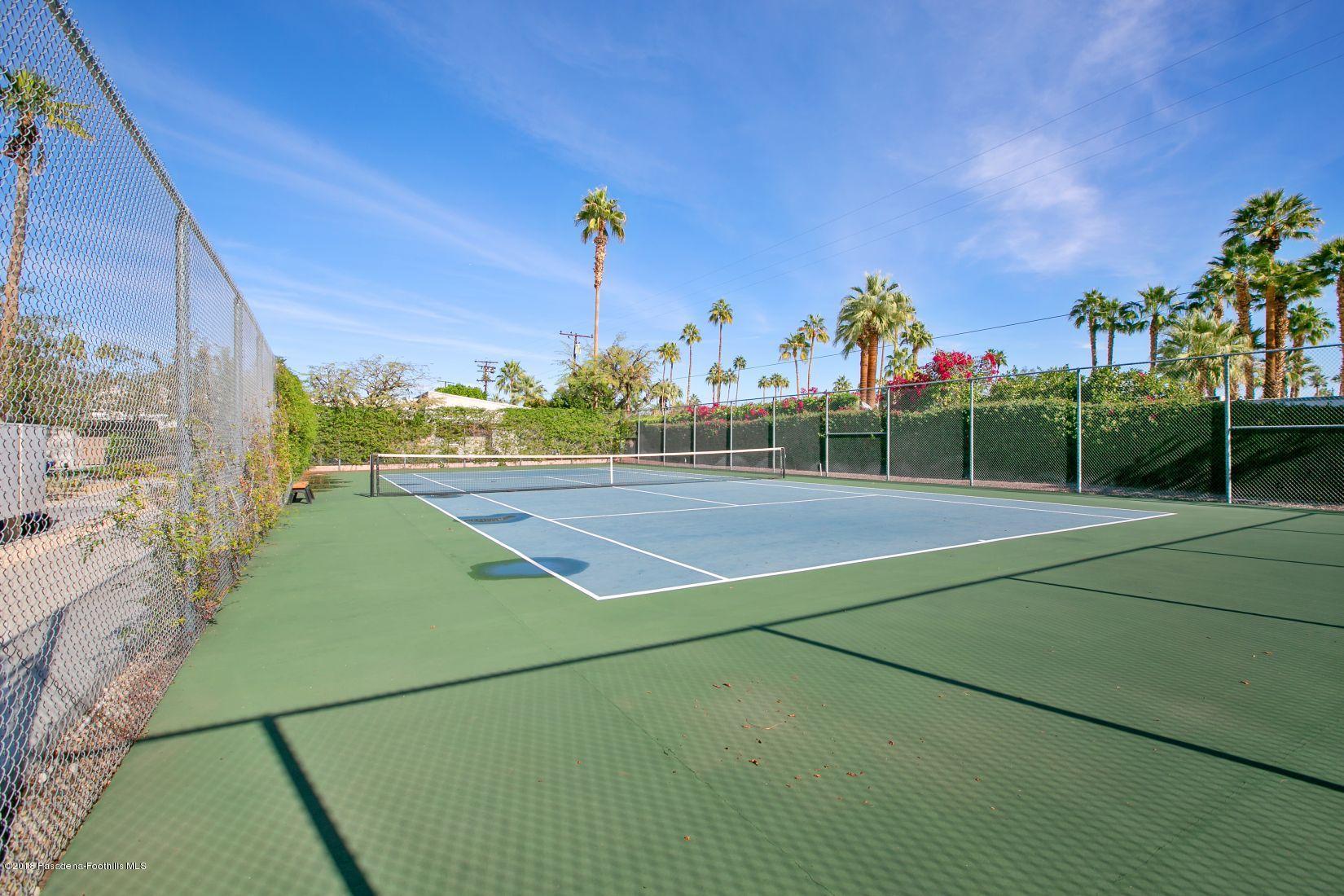 1111 East Ramon Road, Unit 85 Palm Springs, CA 92264 - Photo 27 of 29 a view of an outdoor space and tennis court