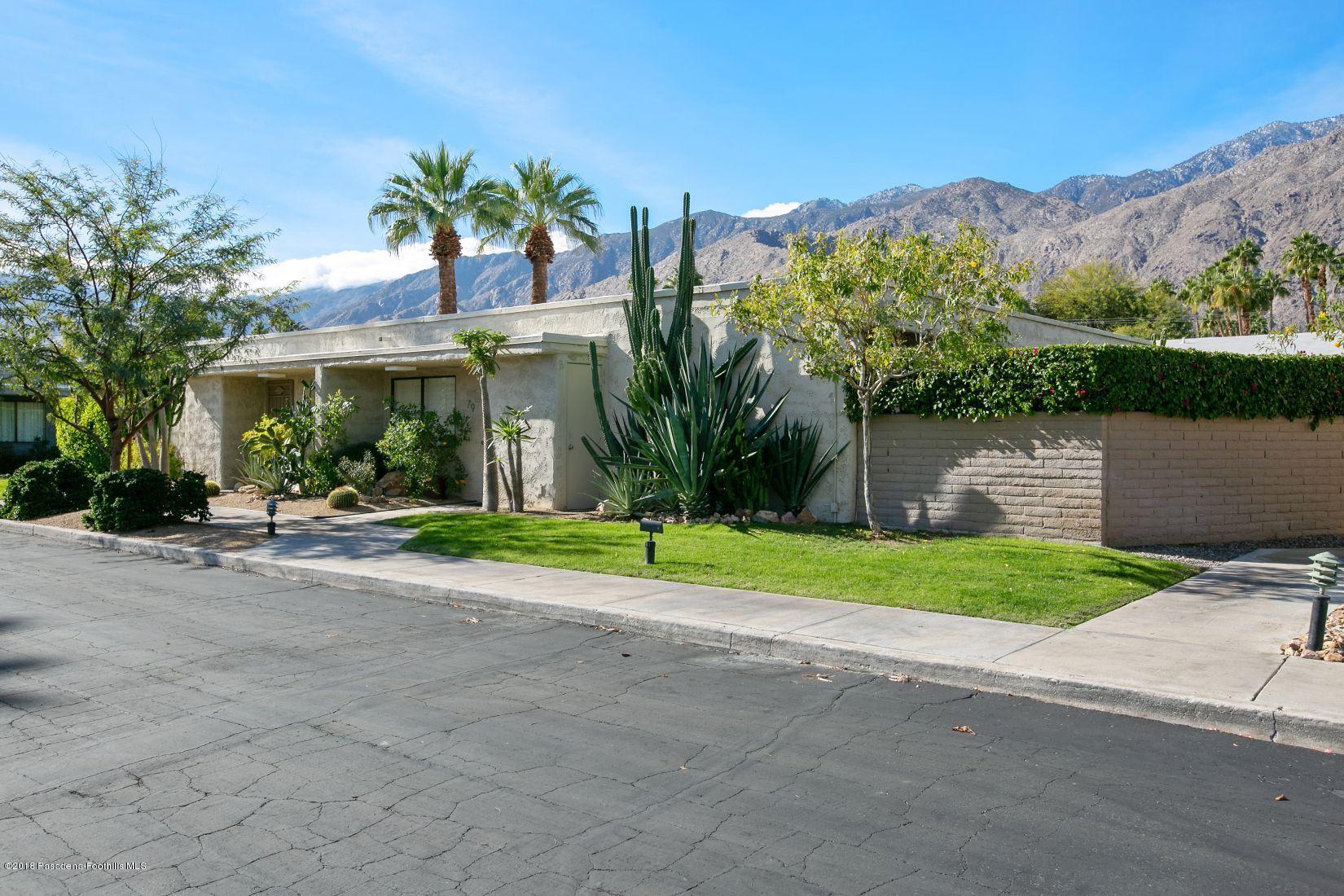 1111 East Ramon Road, Unit 85 Palm Springs, CA 92264 - Photo 28 of 29 front view of a house with a yard and potted plants