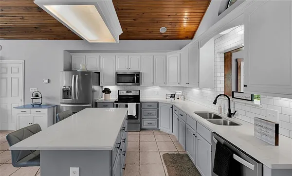 a kitchen with cabinets a sink and appliances