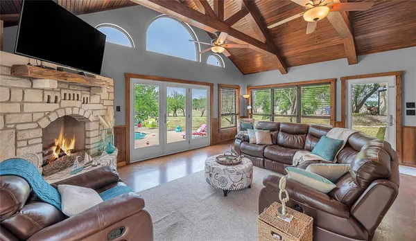 a living room with furniture a fireplace and a flat screen tv