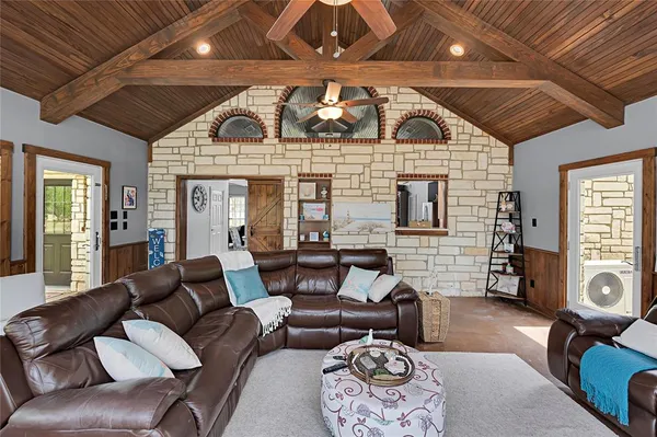 a living room with furniture a fireplace and a flat screen tv