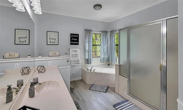 a bathroom with a sink a mirror and a shower