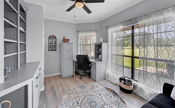 a view of a livingroom with workspace and a window