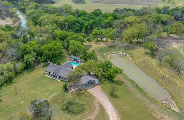 an aerial view of a house with a yard basket ball court and outdoor seating
