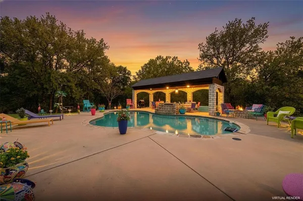 a view of house with swimming pool and sitting area
