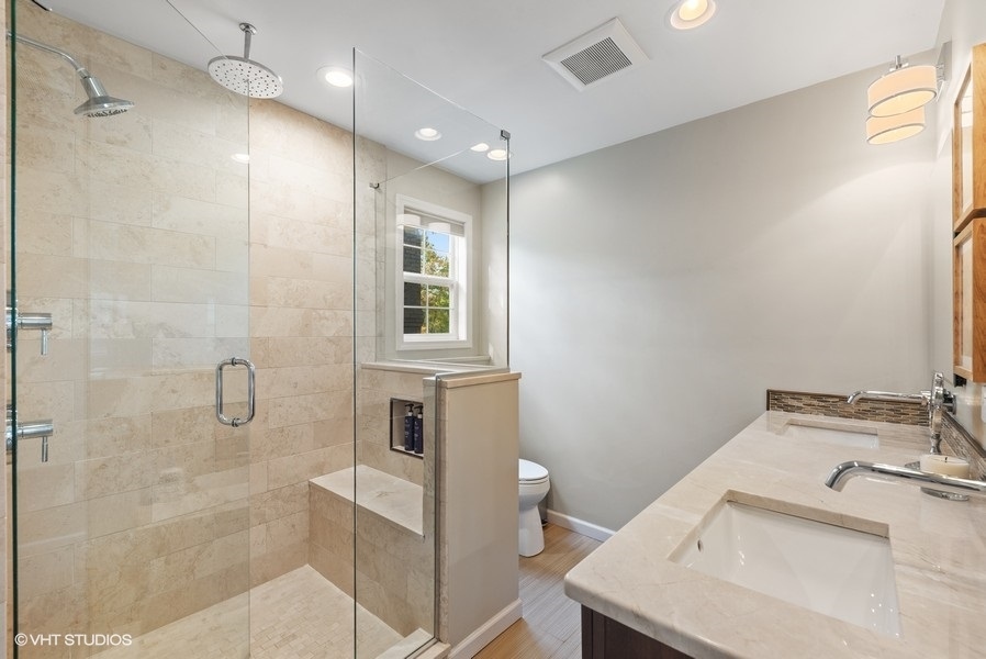 7 Knoll Ridge Road Rolling Meadows, IL 60008 - Photo 18 of 37 a bathroom with a granite countertop sink a toilet and shower
