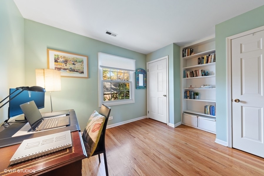 7 Knoll Ridge Road Rolling Meadows, IL 60008 - Photo 23 of 37 a workspace with wooden floor and furniture