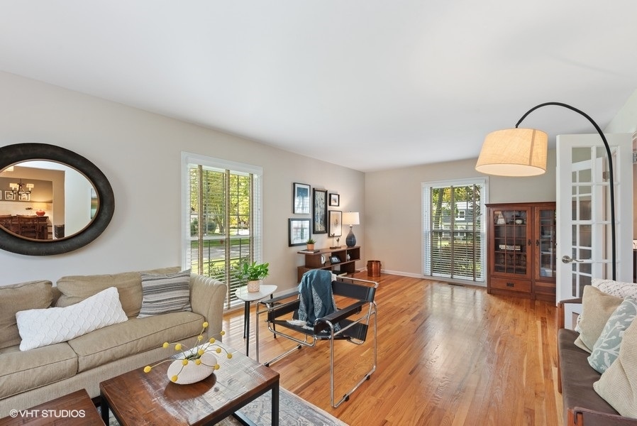 7 Knoll Ridge Road Rolling Meadows, IL 60008 - Photo 6 of 37 a living room with furniture a fireplace and wooden floor