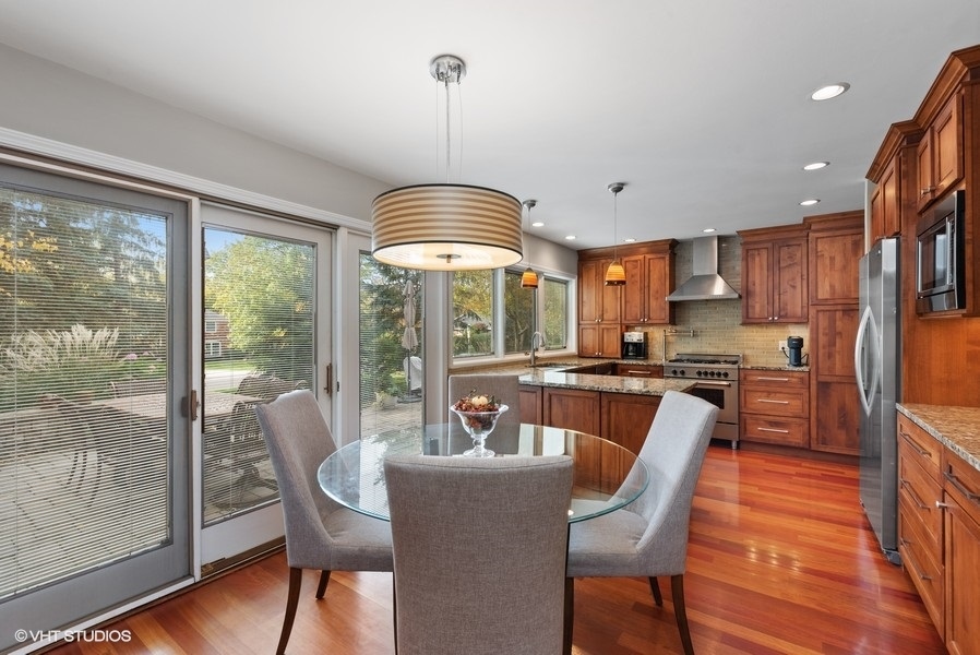 7 Knoll Ridge Road Rolling Meadows, IL 60008 - Photo 9 of 37 a dining room with furniture a chandelier and wooden floor
