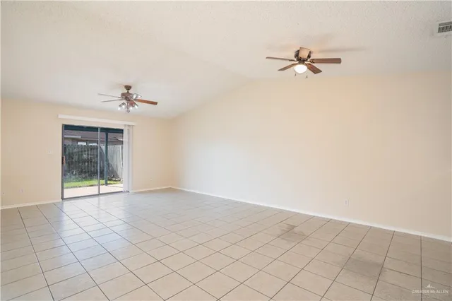 a view of a room with a ceiling fan and window