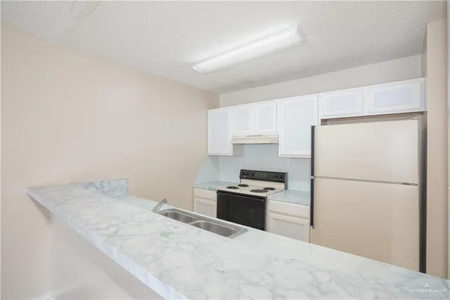 a view with a sink and cabinets