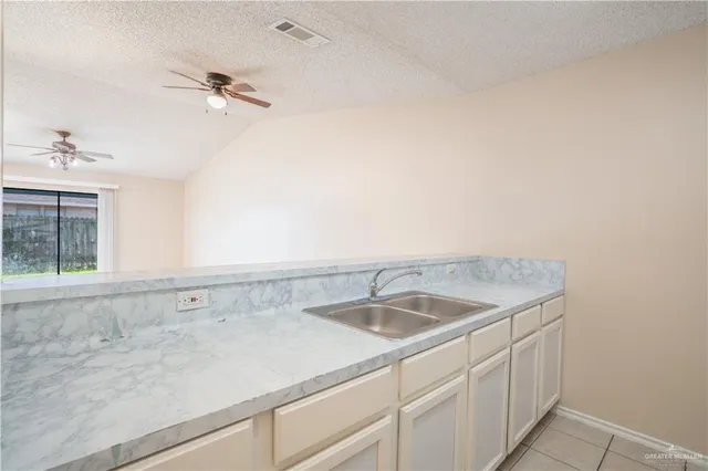 a kitchen with a sink and refrigerator