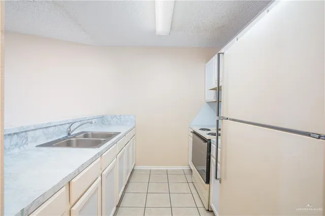 a kitchen with a stove and a refrigerator