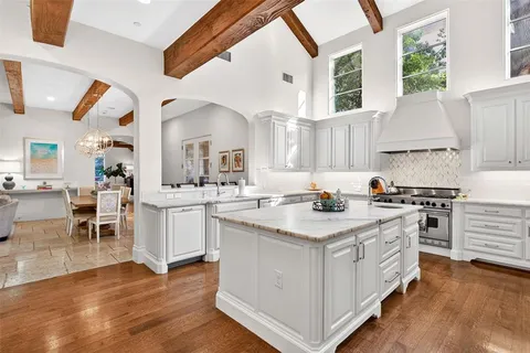 a kitchen with granite countertop a stove sink and cabinets