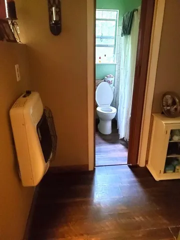 a bathroom with a toilet and a mirror