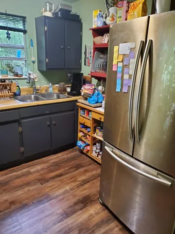 a kitchen with stainless steel appliances granite countertop a refrigerator and a sink