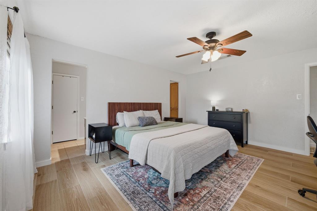 224 Overcrest Drive Benbrook, TX 76126 - Photo 18 of 39 a bedroom with a bed and a chandelier