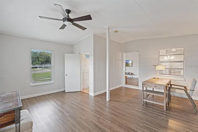 a view of a livingroom with wooden floor and a window