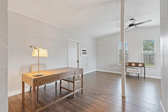 a view of a workspace with furniture and wooden floor