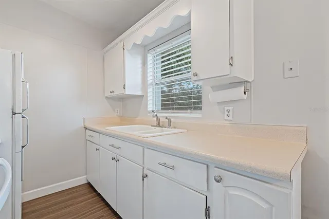 a kitchen with a sink and cabinets