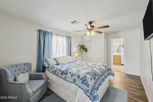 a bedroom with a large bed couch and a window