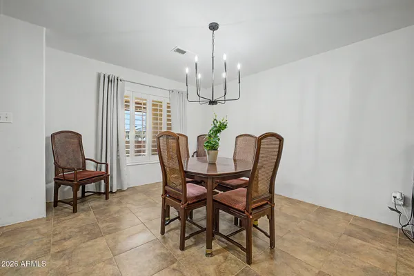 a view of a dining room with furniture a chandelier and wooden floor