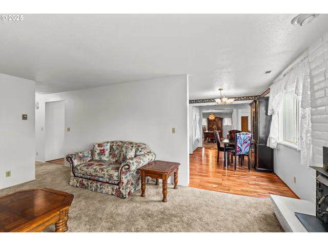 a view of an empty room with window and cabinet
