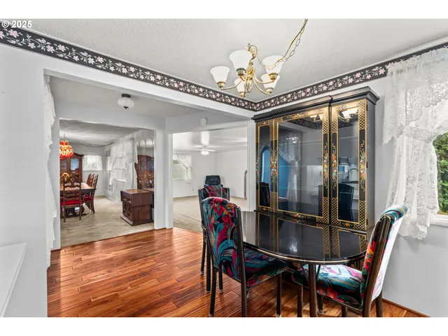 a view of a dining room with furniture and a chandelier