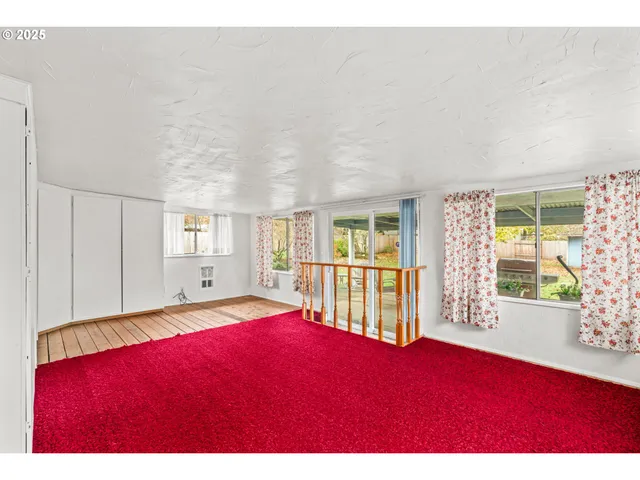 a living room with furniture and large window
