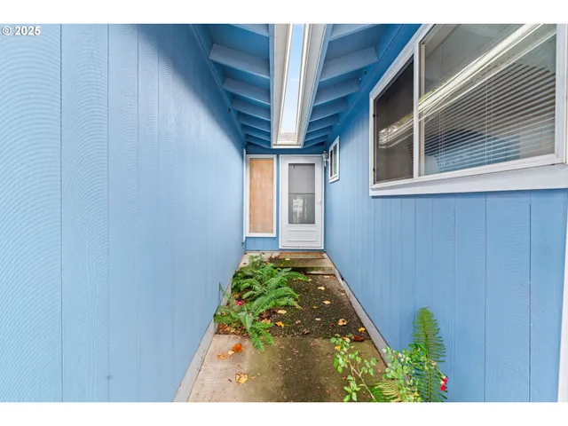 a view of hallway with wooden floor