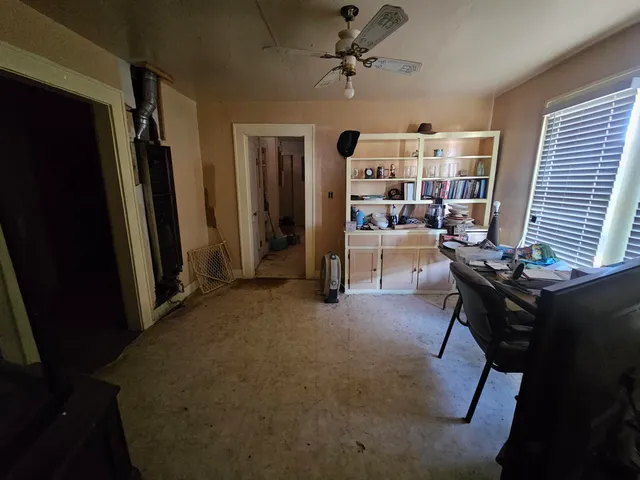 a view of a livingroom with furniture and a window