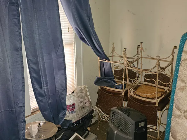 a room with exposed radiator and window