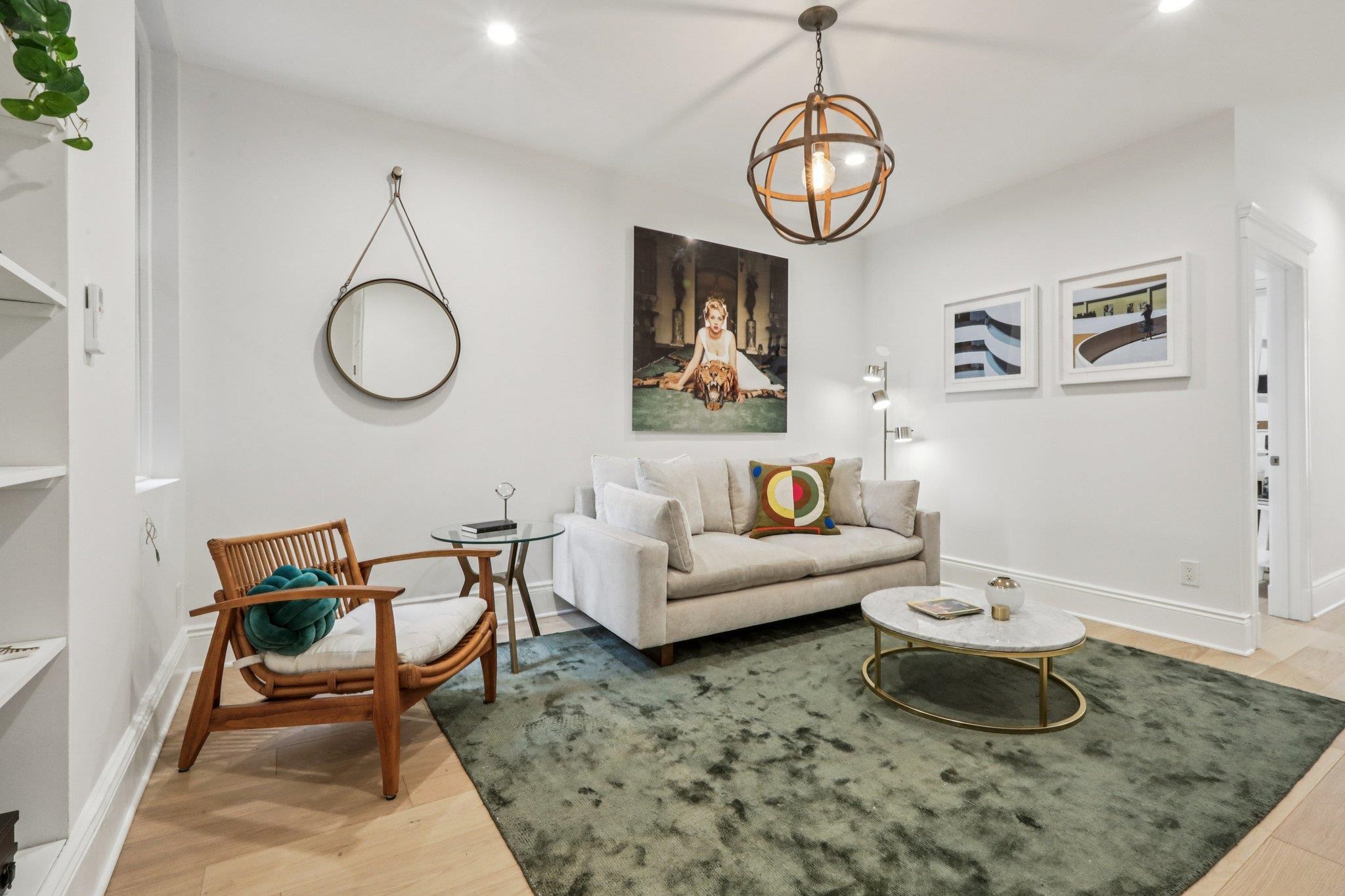 97 Clifton Terrace, Unit 6 Weehawken, NJ 07086 - Photo 1 of 36 a living room with furniture and a table