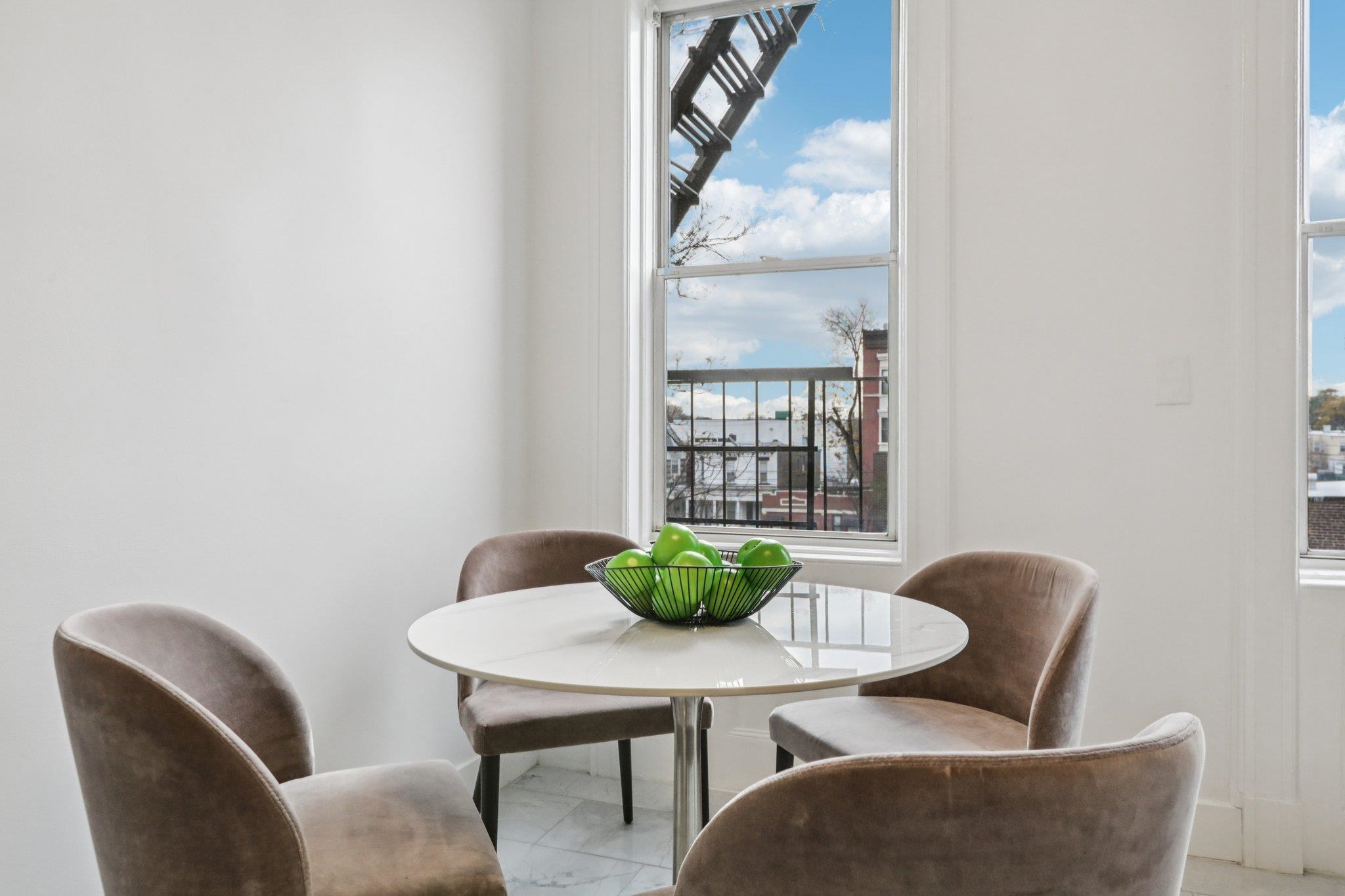 97 Clifton Terrace, Unit 6 Weehawken, NJ 07086 - Photo 12 of 36 a dining room with furniture and window