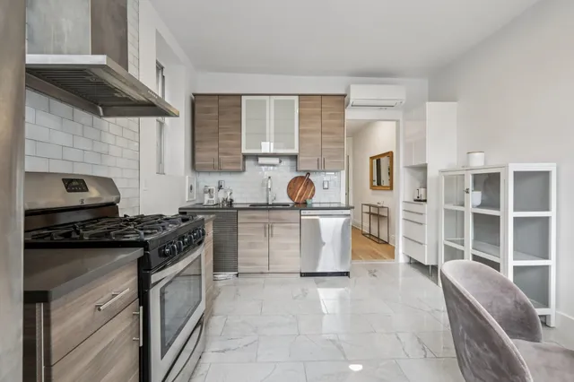 a kitchen with a stove a sink and a refrigerator