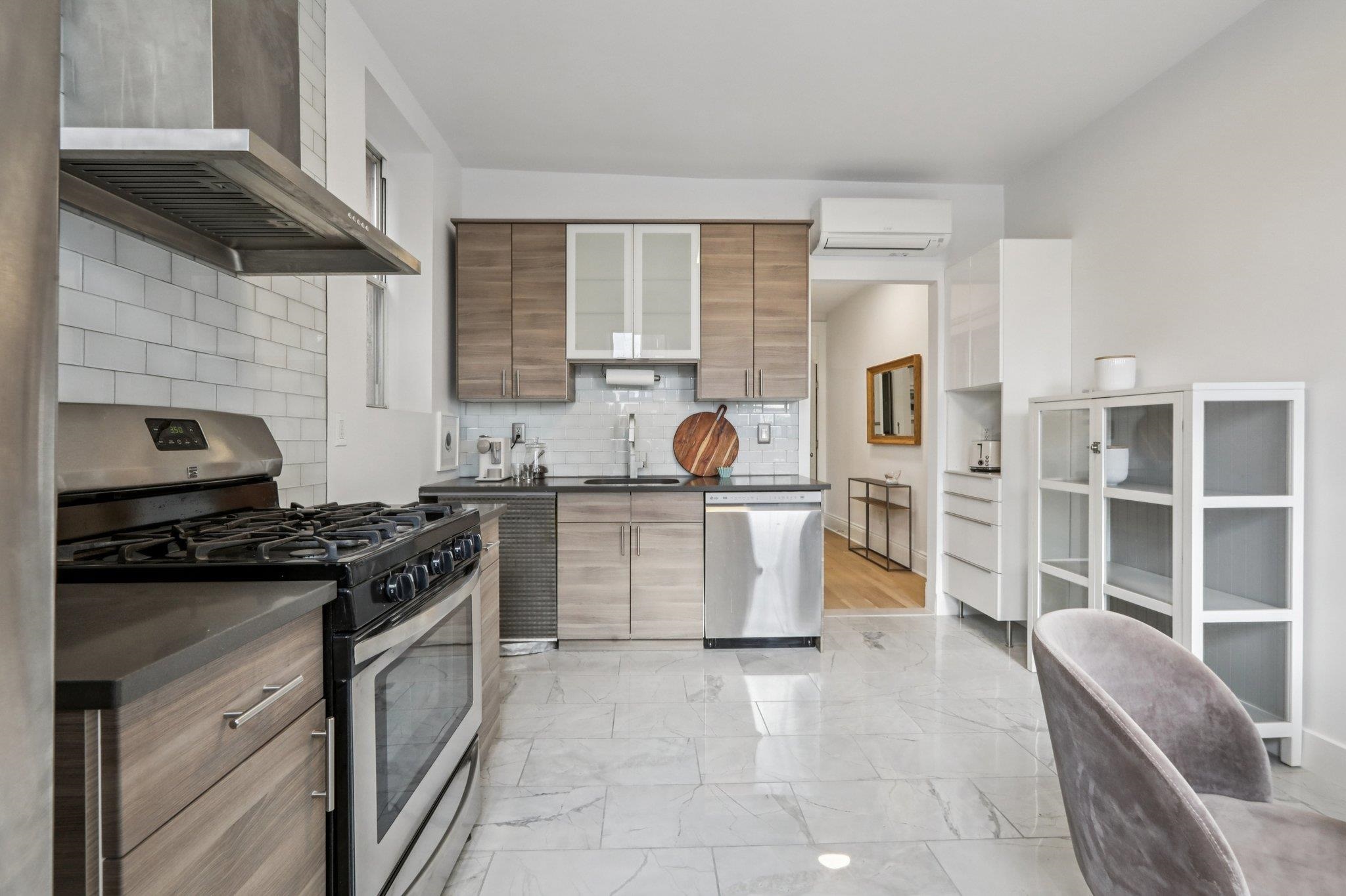 97 Clifton Terrace, Unit 6 Weehawken, NJ 07086 - Photo 13 of 36 a kitchen with a stove a sink and a refrigerator