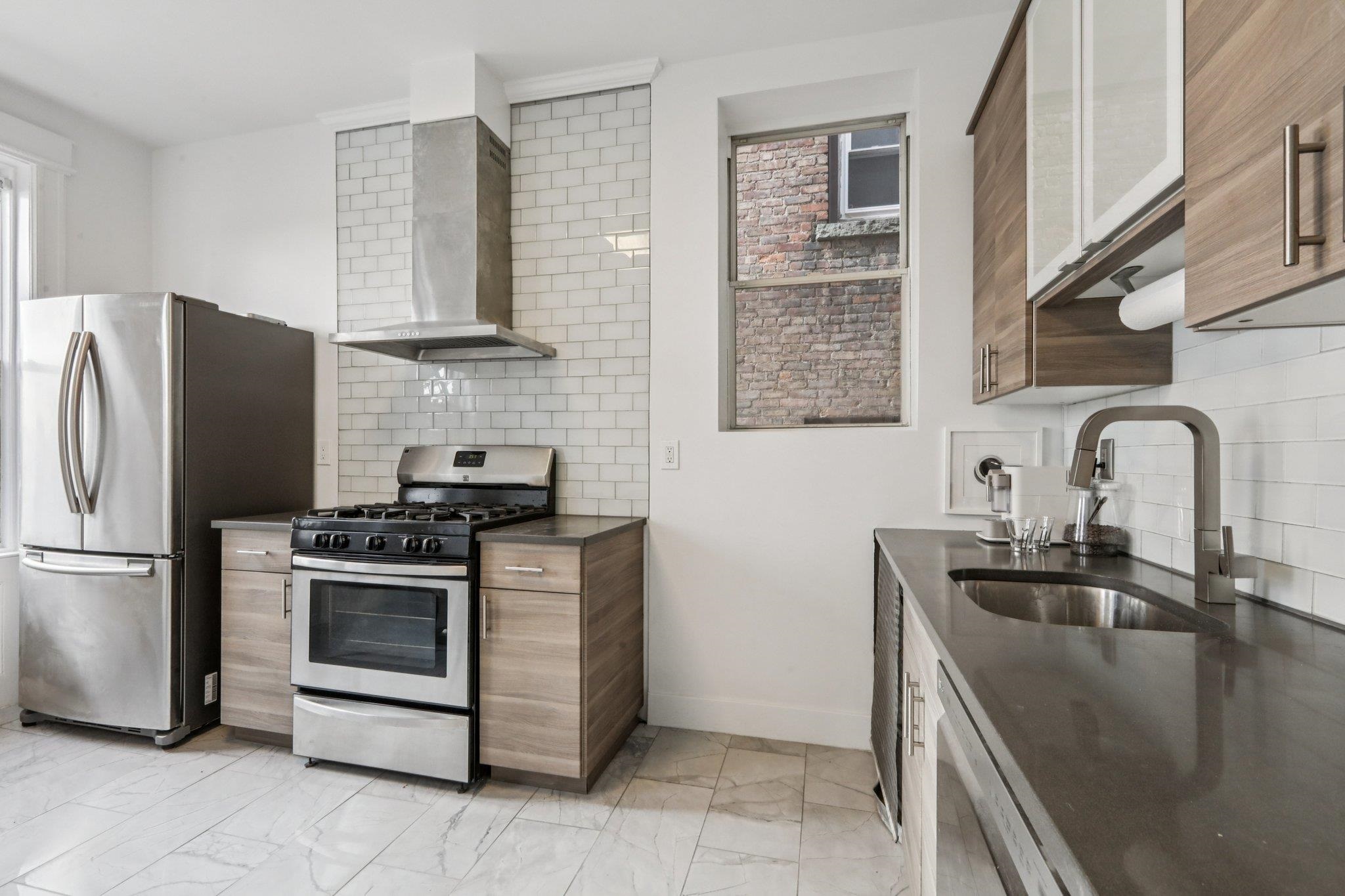 97 Clifton Terrace, Unit 6 Weehawken, NJ 07086 - Photo 15 of 36 a kitchen with stainless steel appliances granite countertop a sink stove and refrigerator
