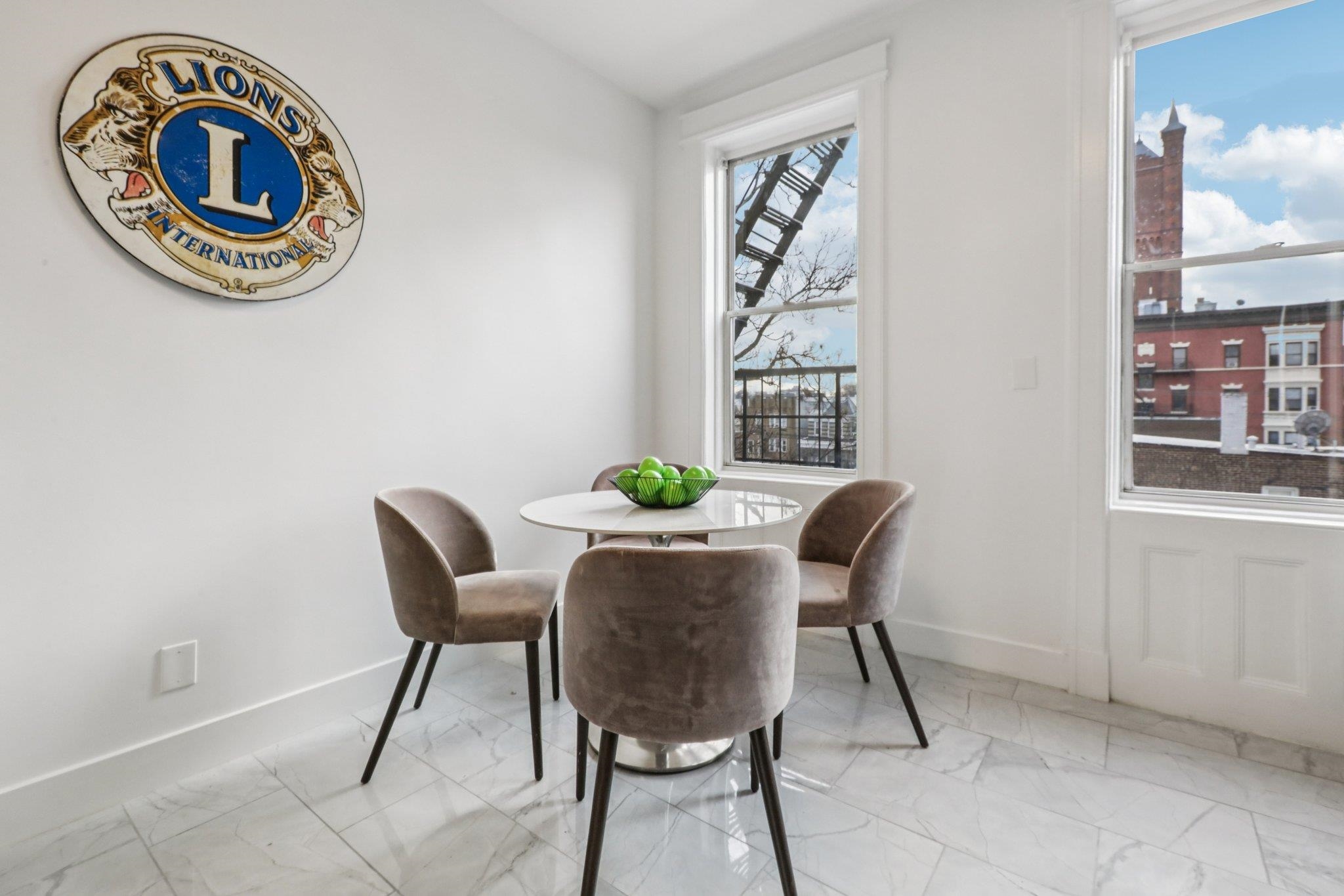 97 Clifton Terrace, Unit 6 Weehawken, NJ 07086 - Photo 18 of 36 a dining room with furniture and a window