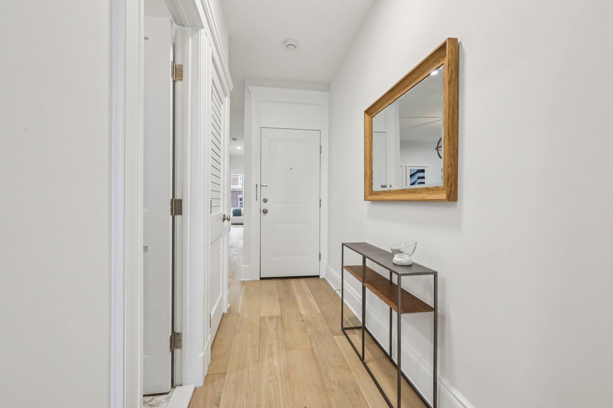 97 Clifton Terrace, Unit 6 Weehawken, NJ 07086 - Photo 19 of 36 a view of a hallway with wooden floor and staircase