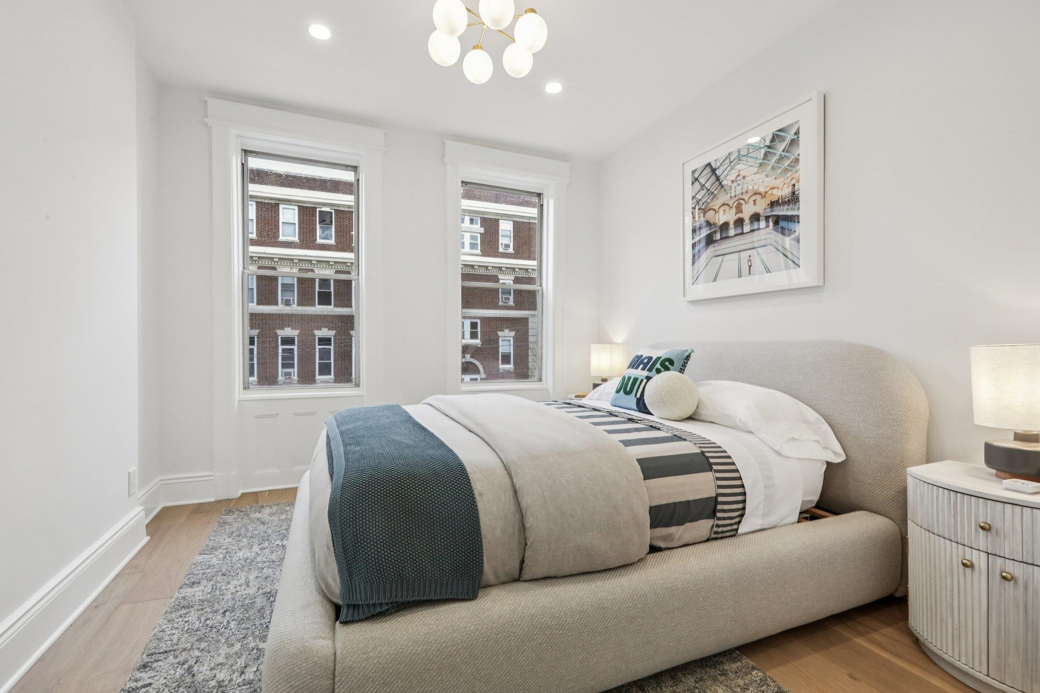 97 Clifton Terrace, Unit 6 Weehawken, NJ 07086 - Photo 20 of 36 a bedroom with a large bed and a window